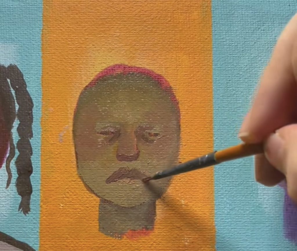 Painting facial features on a mini portrait